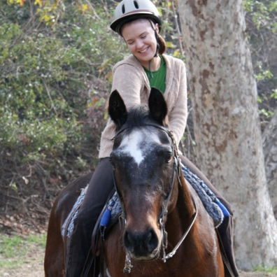 an image of a girl on horseback